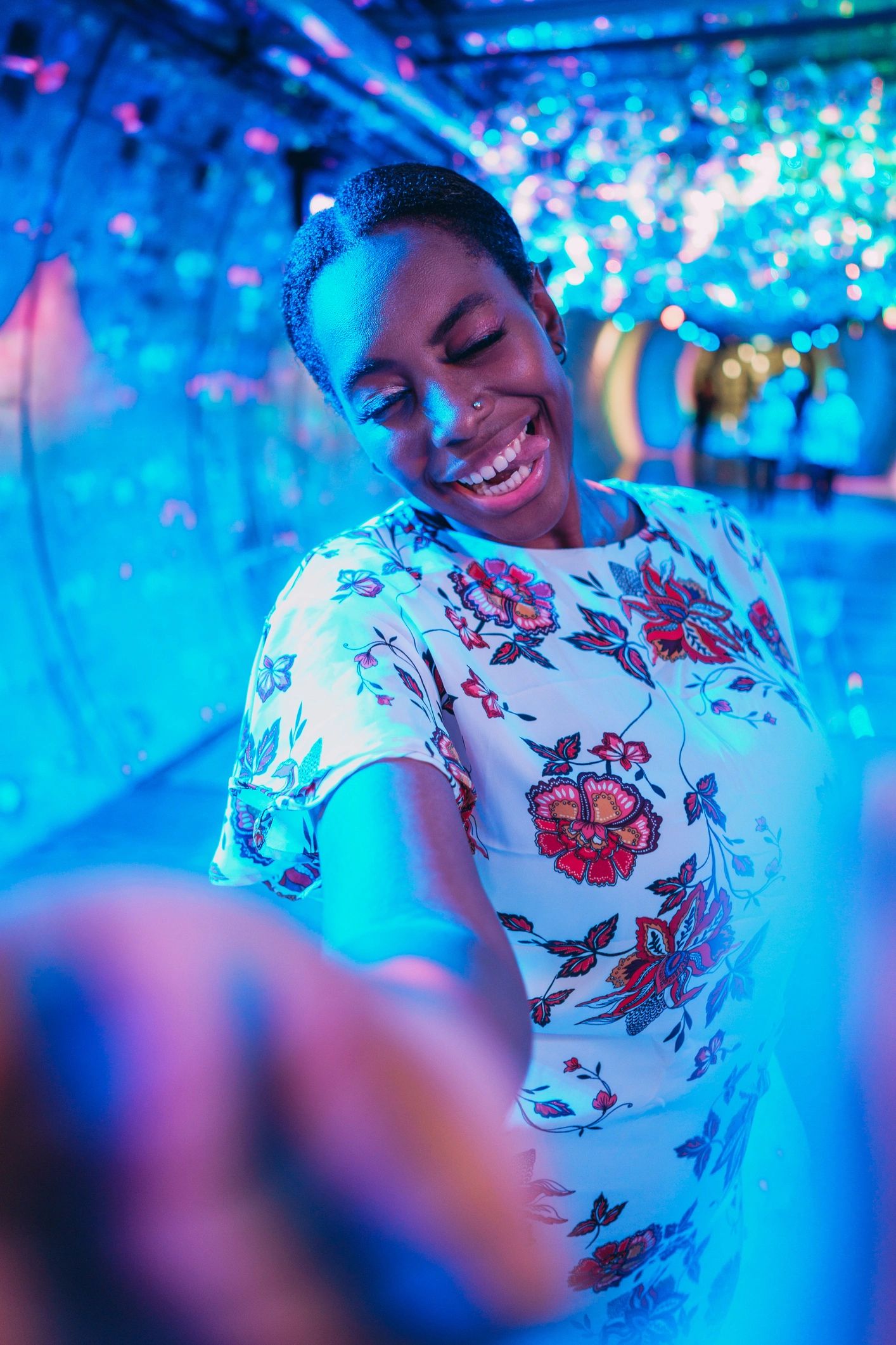 Smiling woman taking a selfie in colorful neon lights