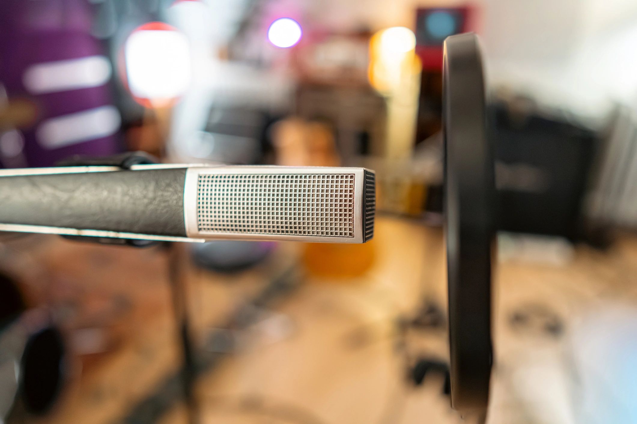 Microphone with pop filter in a studio, representing recording and voice confidence